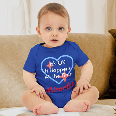 Bella+Canvas baby onesie with “Miracles Happen” design and uplifting message, soft cotton, envelope neck and snap closure, Christian apparel for infants and family matching, baby boy in blue onesie